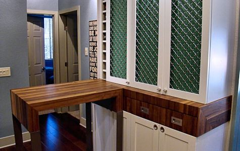 Custom rolling walnut table with partial returns with a mitre joint on a flat metal base.  With a custom matching drawer cabinet.