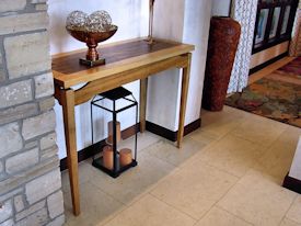 Custom hall table with a Texas Pecan framed Zebrawood floating top.