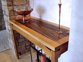 Custom hall table with a Texas Pecan framed Zebrawood floating top.