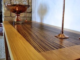 Custom hall table with a Texas Pecan framed Zebrawood floating top.