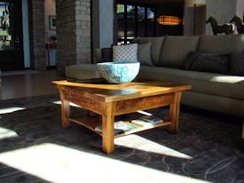 Custom Spalted Pecan square coffee table with custom designed carved aprons and shaped shelf.