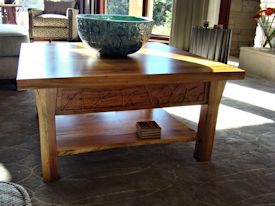 Custom Spalted Pecan square coffee table with custom designed carved aprons and shaped shelf.