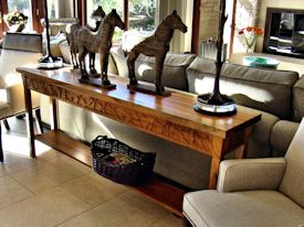 Custom Spalted Pecan sofa table with custom designed carved aprons and shaped shelf.