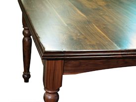 Custom distressed Walnut dining table with custom designed turned legs and arched aprons. 