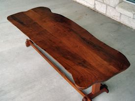 Custom mesquite coffee table with mahogany trestle style base.   