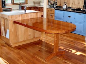 Custom cherry trestle style penninsula table with hard maple accents.