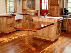 Custom cherry trestle style penninsula table with hard maple accents.