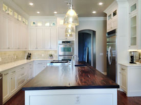 Alder face grain island countertop Custom Distressing, Dark Walnut Stain and a Waterlox Satin Finish.