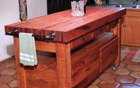 Custom mesquite chef's table with a 4 inch thick edge grain top, mortise and tenon jointery, and full extension drawers.