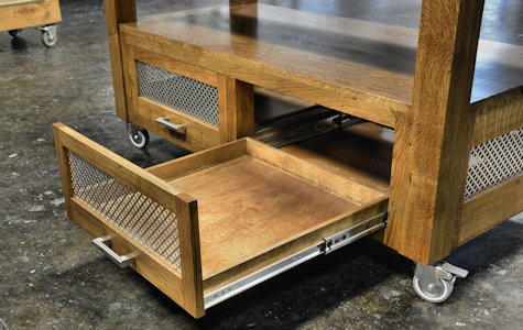 Custom solid wood Chef's Cart with Mesquite end grain chopping block featuring a juice groove, marble inset, and knife block insert.  Towel rack made of Mesquite and White Oak.  Cart base made of solid White Oak. Three drawers and two slide out trays with a punched steel design.