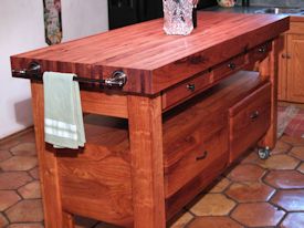 Custom mesquite chef's table with a 4 inch thick edge grain top, mortise and tenon jointery, and full extension drawers.