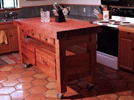 Custom mesquite chef's table with a 4 inch thick edge grain top, mortise and tenon jointery, and full extension drawers.
