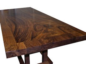 Custom Banquette Table.  Constructed using Slab Guanacaste with a Face Grain Walnut Band and a Custom Walnut Table Base.  Waterlox Satin Finish.