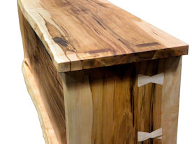Custom Entertainment Center made from Ambrosia Maple Slabs.  Natural Edges on Face.  Mortise and Tenon Jointery.  Maple Butterfly Detailing.  Adjustable Shelves.  Cord Cutouts.  Tung Oil Citrus Finish.