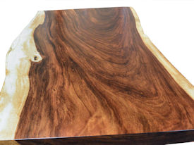 Custom dining table using a Guanacaste Slab Top with Natural Edges and Waterlox Satin finish.  Custom flat black metal base.