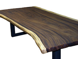 Custom dining table using a Guanacaste Slab Top with Natural Edges and Tung Oil Citrus finish.  Custom flat black metal base.