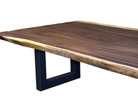 Custom dining table using a Guanacaste Slab Top with Natural Edges and Tung Oil Citrus finish.  Custom flat black metal base.