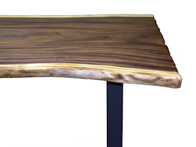 Custom dining table using a Guanacaste Slab Top with Natural Edges and Tung Oil Citrus finish.  Custom flat black metal base.