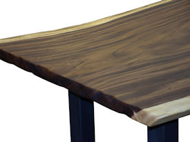 Custom dining table using a Guanacaste Slab Top with Natural Edges and Tung Oil Citrus finish.  Custom flat black metal base.