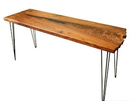 Custom hall table using walnut slab with one wane edge and metal base.