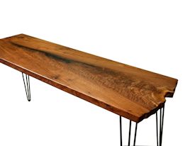 Custom hall table using walnut slab with one wane edge and metal base.