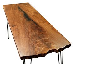 Custom hall table using walnut slab with one wane edge and metal base.