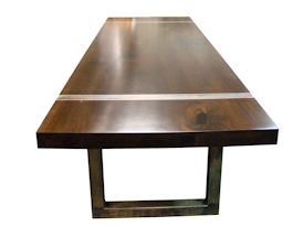 Custom dining table using book-matched walnut slabs with a drop edge for the top.  Custom steel base and accent bands with a hand rubbed (bronze) finish.