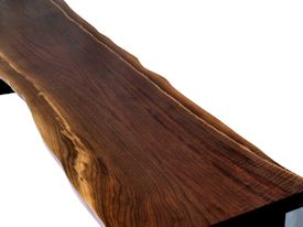 Custom bench using walnut slab and a custom flat black metal base.