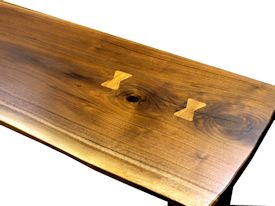 Custom hall table using a walnut slab top with inlaid hard maple butterfly accents and a custom flat black metal base. 