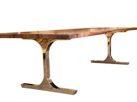 Custom dining table using walnut slabs with wane edges on a custom handmade mirror polished bronze base.