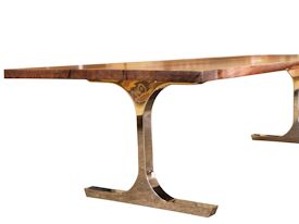 Custom dining table using walnut slabs with wane edges on a custom handmade mirror polished bronze base.