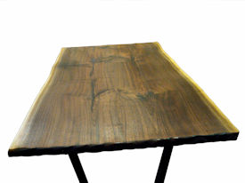 Custom Walnut Bookmatched Slab Table with Natural Edges, a Tung-Oil Finish and a flat black metal base. 