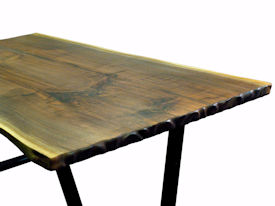 Custom Walnut Bookmatched Slab Table with Natural Edges, a Tung-Oil Finish and a flat black metal base. 
