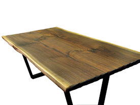 Custom Walnut Bookmatched Slab Table with Natural Edges, a Tung-Oil Finish and a flat black metal base. 