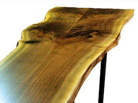 Custom Walnut Bookmatched Slab Table with Natural Edges, a Waterlox Finish and a flat black metal base. 