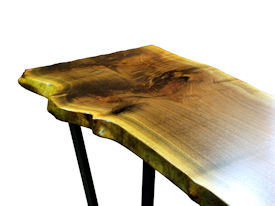 Custom Walnut Bookmatched Slab Table with Natural Edges, a Waterlox Finish and a flat black metal base. 