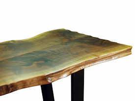 Custom Walnut Bookmatched Slab Table with Natural Edges, a Waterlox Finish and a flat black metal base. 