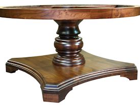 Custom round walnut table with turned pedestal-style base