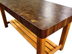 Custom walnut butcher block chopping table with cherry base.  this table uses mortise and tenon jointery and has a slat-style shelf.  The top is constructed using 1-3/4 inch square blocks and is 5 inches thick.  It has a softened edge and is finished with Tung Oil/Citrus Solvent.  Custom Crafted for Ramindesign LLC.