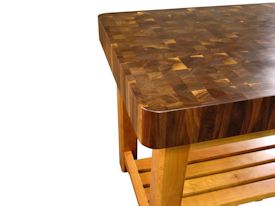 Custom walnut butcher block chopping table with cherry base.  this table uses mortise and tenon jointery and has a slat-style shelf.  The top is constructed using 1-3/4 inch square blocks and is 5 inches thick.  It has a softened edge and is finished with Tung Oil/Citrus Solvent.  Custom Crafted for Ramindesign LLC.
