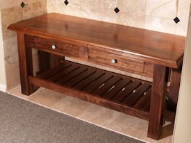 Custom walnut table with false drawer fronts and slat style shelf.