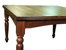 Custom distressed Walnut dining table with custom designed turned legs and arched aprons. 