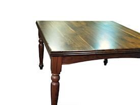 Custom distressed Walnut dining table with custom designed turned legs and arched aprons.