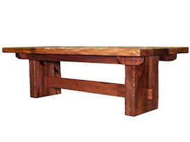 Custom face grain argentinean mesquite dining table.  Rustic trestle-style construction with through mortise and tenon jointery and hand carved edges.