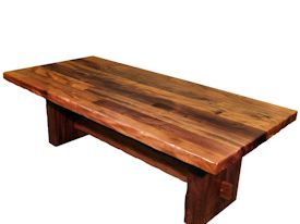 Custom face grain argentinean mesquite dining table.  Rustic trestle-style construction with through mortise and tenon jointery and hand carved edges.