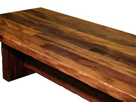 Custom face grain argentinean mesquite dining table.  Rustic trestle-style construction with through mortise and tenon jointery and hand carved edges.