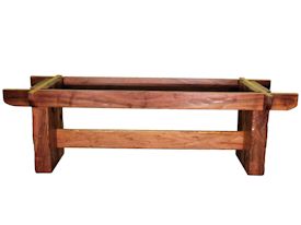Custom face grain argentinean mesquite dining table.  Rustic trestle-style construction with through mortise and tenon jointery and hand carved edges.