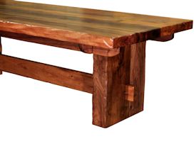 Custom face grain argentinean mesquite dining table.  Rustic trestle-style construction with through mortise and tenon jointery and hand carved edges.