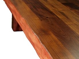 Custom face grain argentinean mesquite dining table.  Rustic trestle-style construction with through mortise and tenon jointery and hand carved edges.