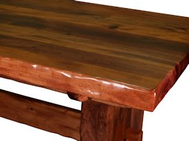 Custom face grain argentinean mesquite dining table.  Rustic trestle-style construction with through mortise and tenon jointery and hand carved edges.